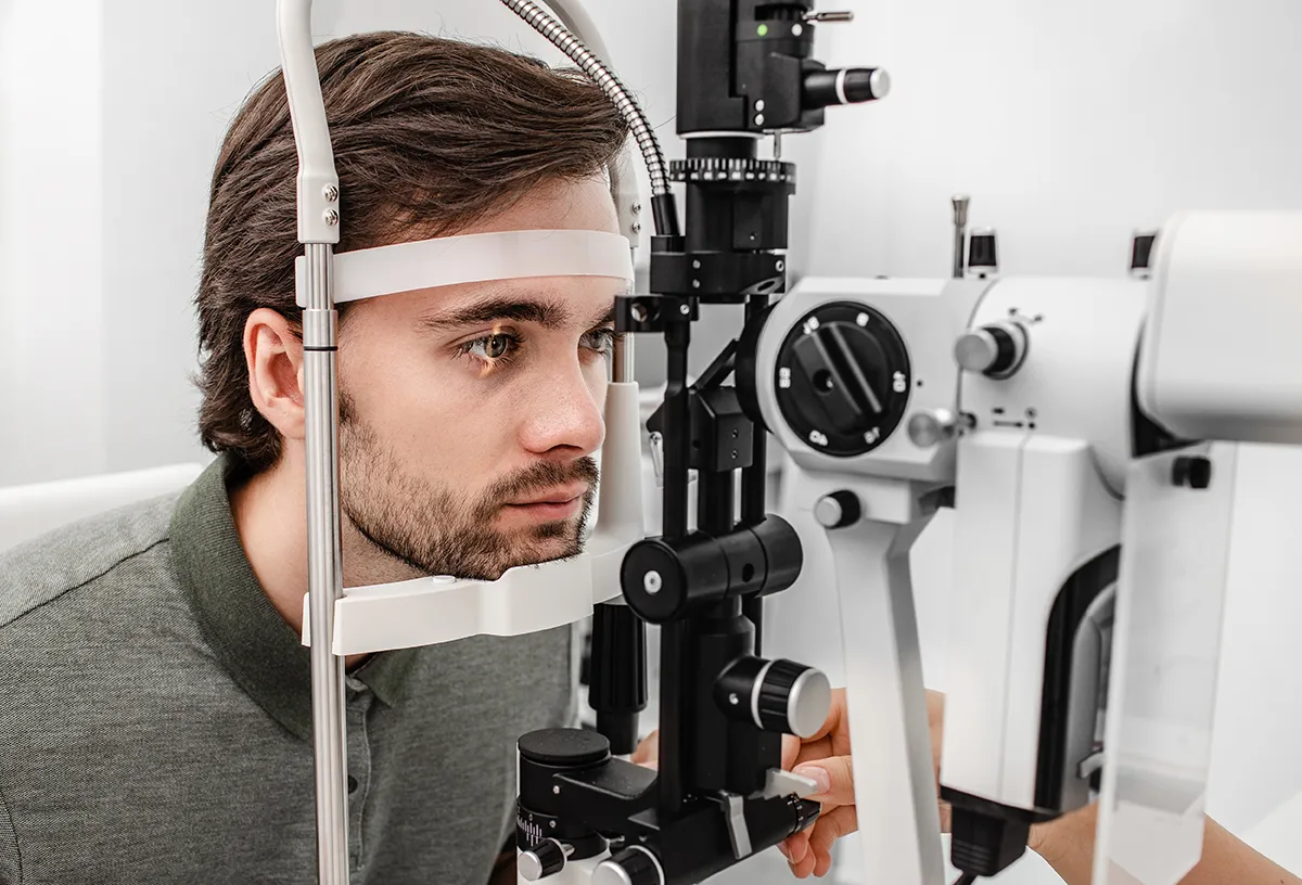 a young man getting an eye exam at the eye doctor's